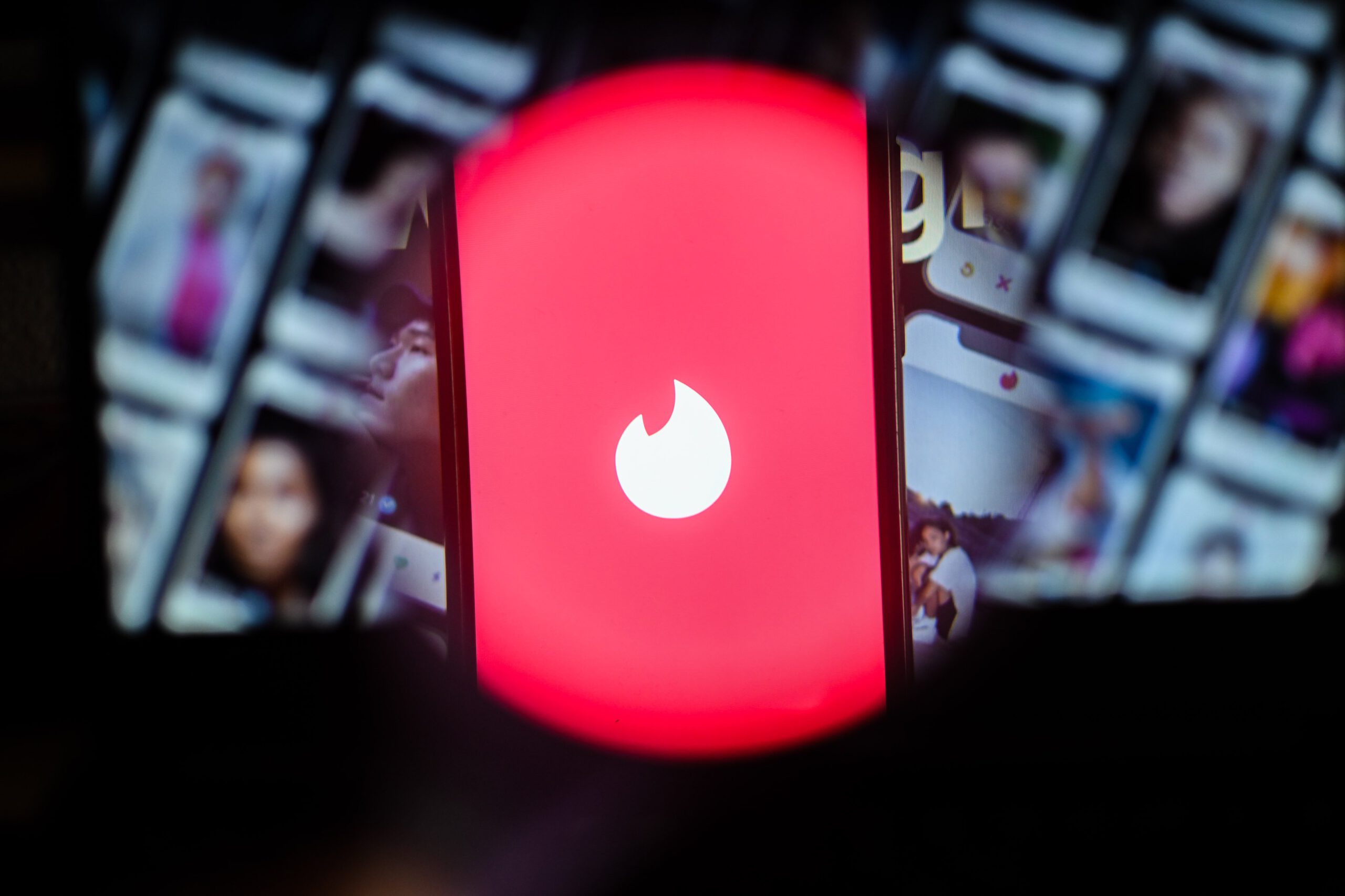 A photo illustration of the dating app Tinder on iPhone screen