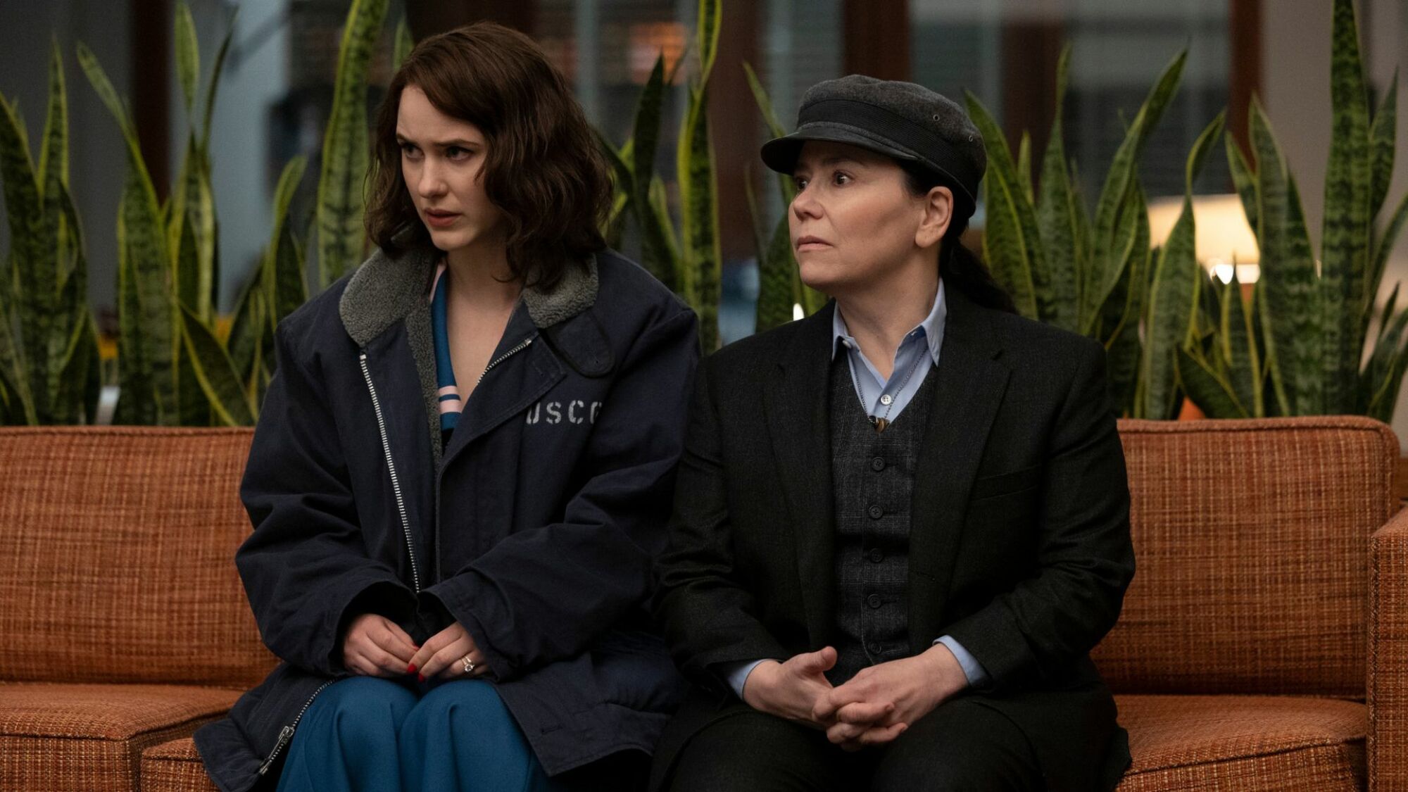 Rachel Brosnahan and Alex Borstein sit on a bench in "The Marvelous Mrs. Maisel."