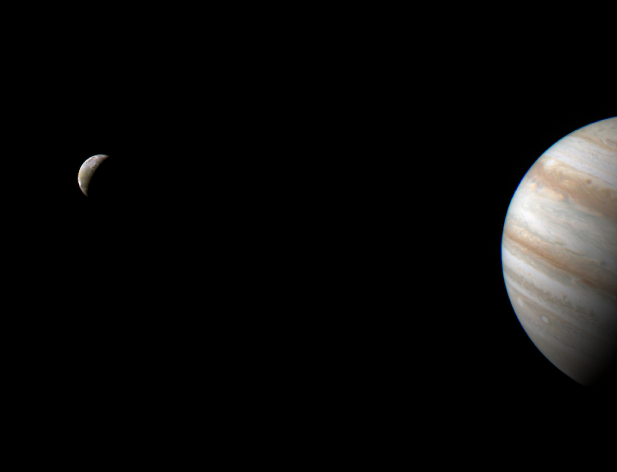 Io on left as the volcanic moon orbits Jupiter, on right.