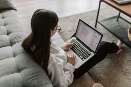 Girl using laptop on lap