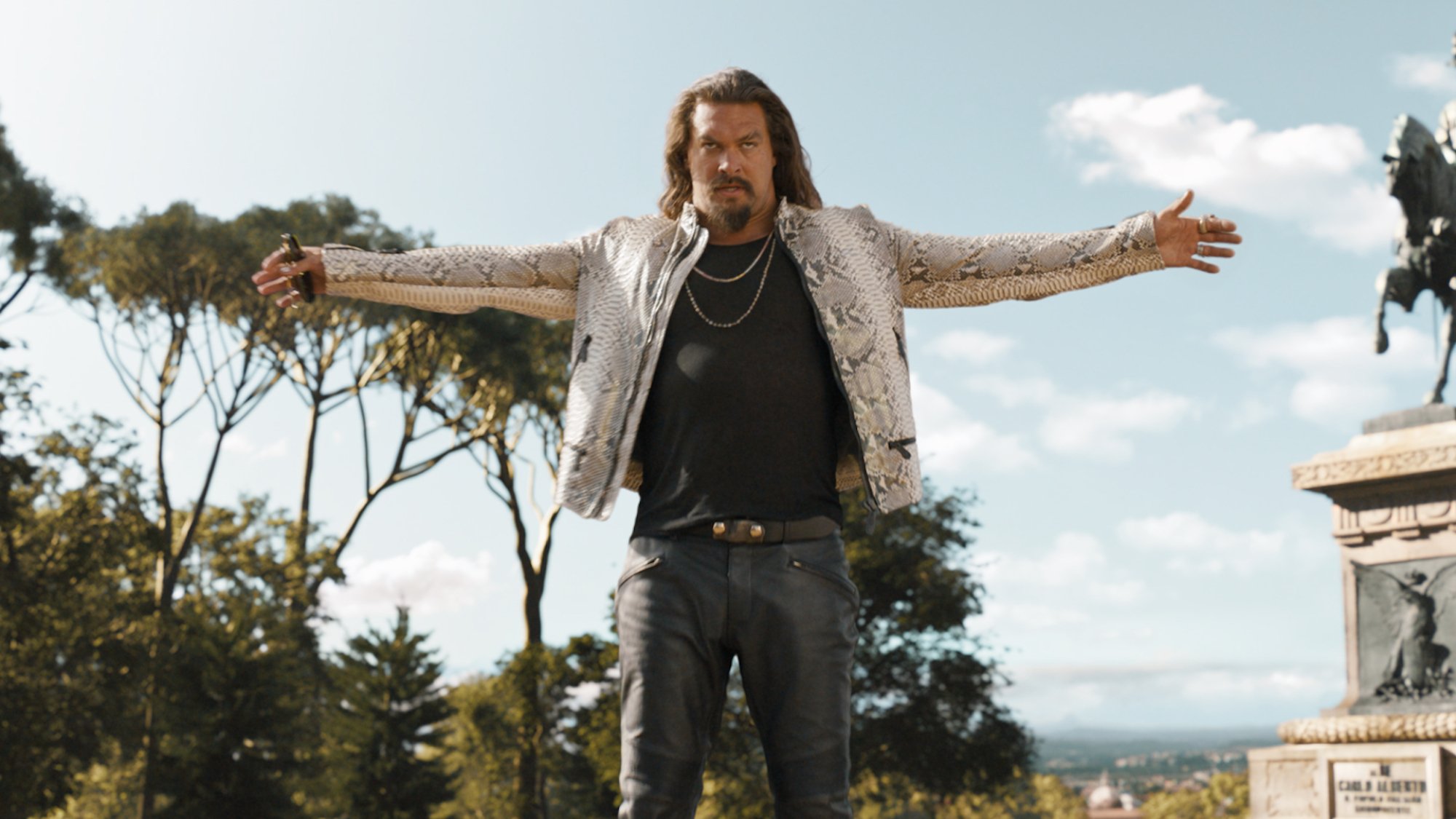 Jason Momoa stands with arms outstretched in the film "Fast X".