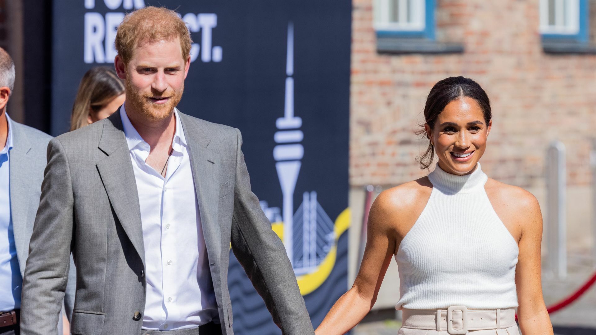 Harry and Meghan holding hands.