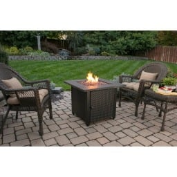 outdoor fire pit on patio surrounded by chairs
