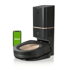 iRobot Roomba s9+ on its charging dock and accompanied by a phone depicting the iRobot app 