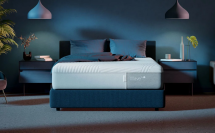 a casper mattress in a staged bedroom lit with blue lighting