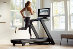 a rear view of a woman running on a nordictrack Commercial 2450 treadmill in a bright living room