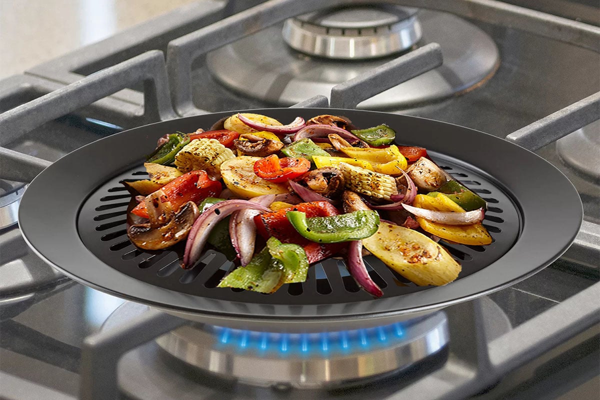 smokeless grill on a stovetop with vegetables