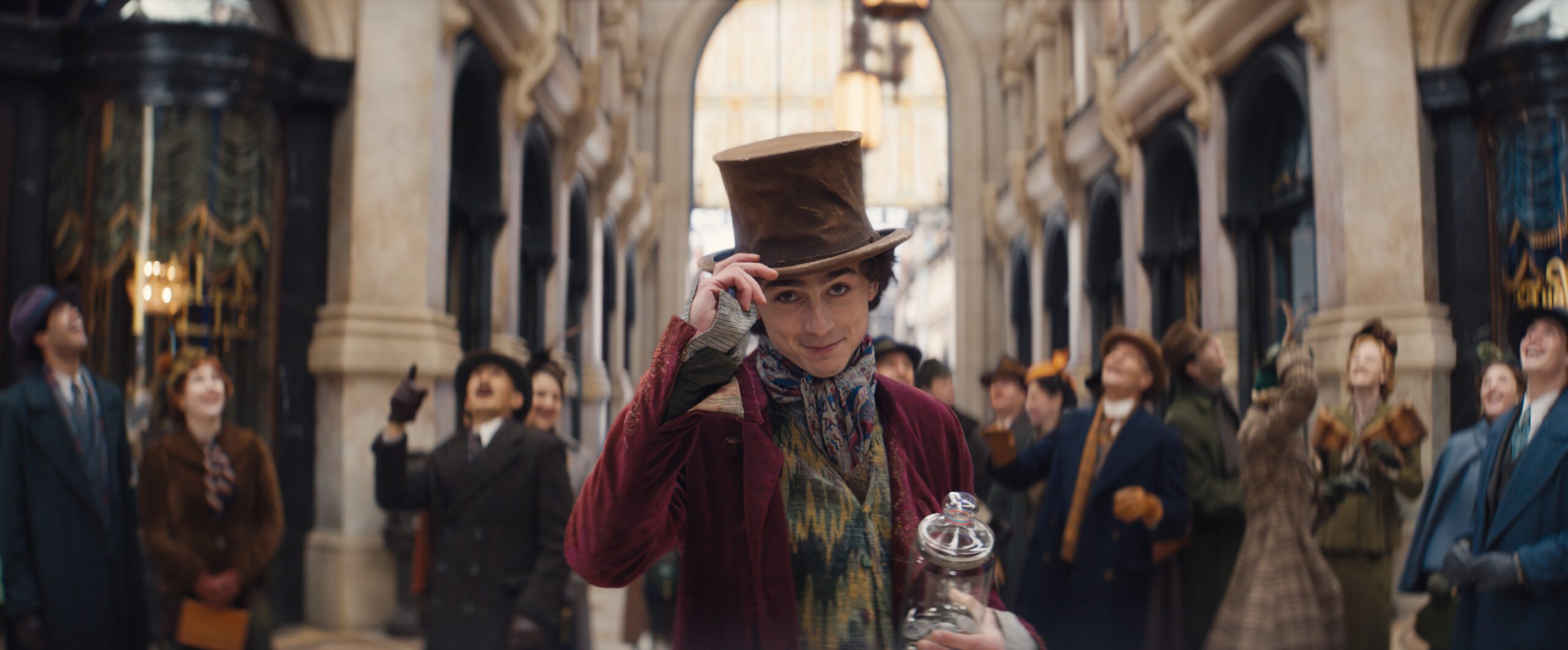 Timothee Chalamet tipping his hat as Willy Wonka in the 'Wonka' trailer. 