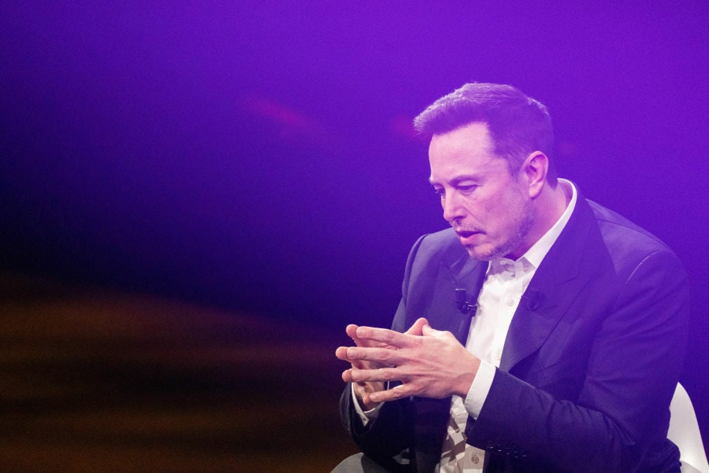 Elon Musk speaking at a conference