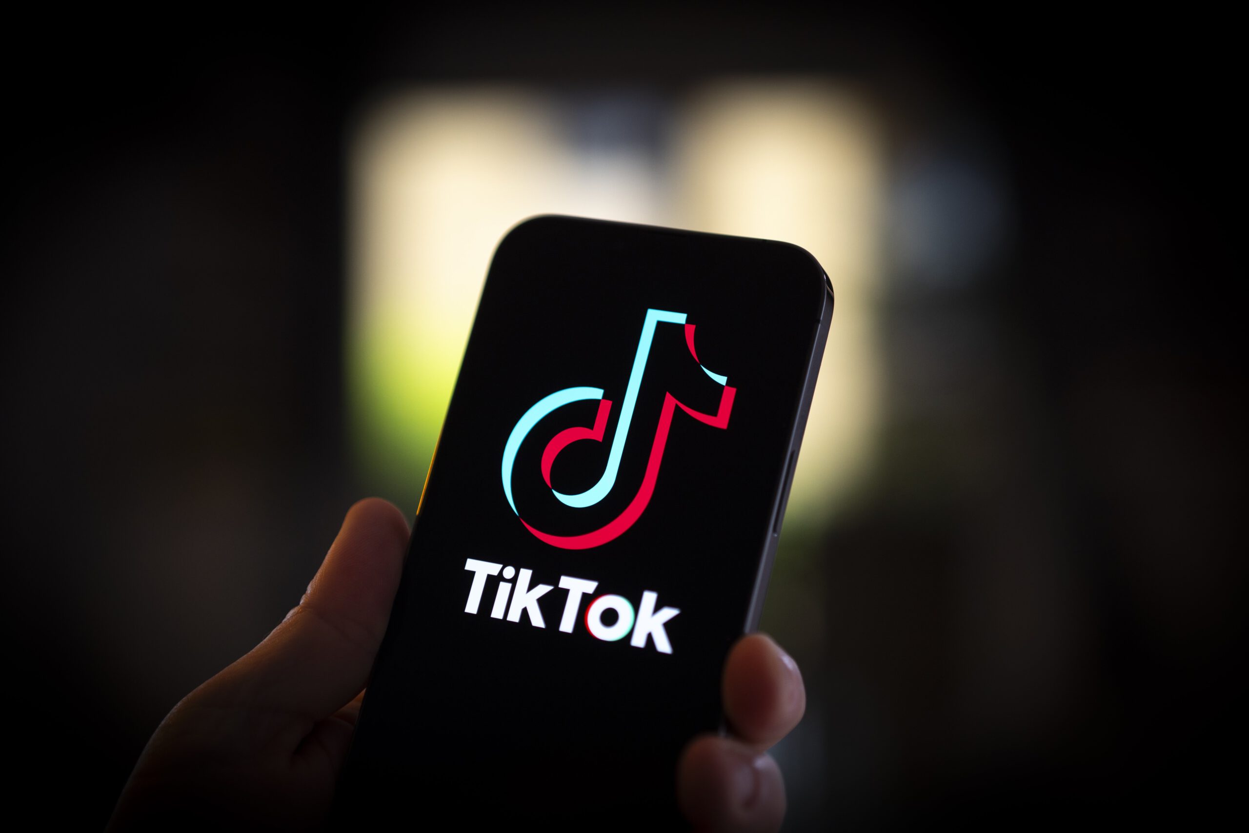 A phone with the TikTok logo displayed on the screen. 