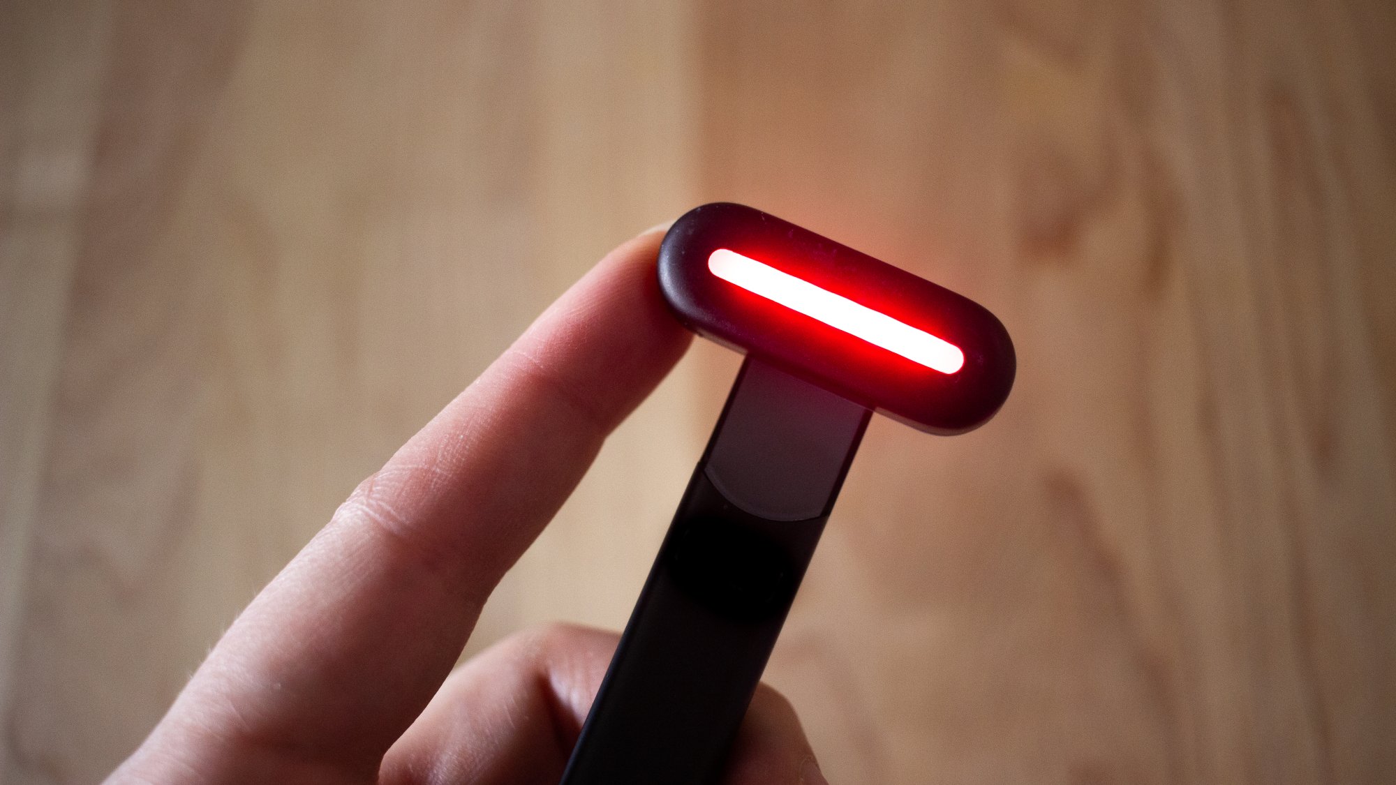 red light glowing at the end of a facial wand