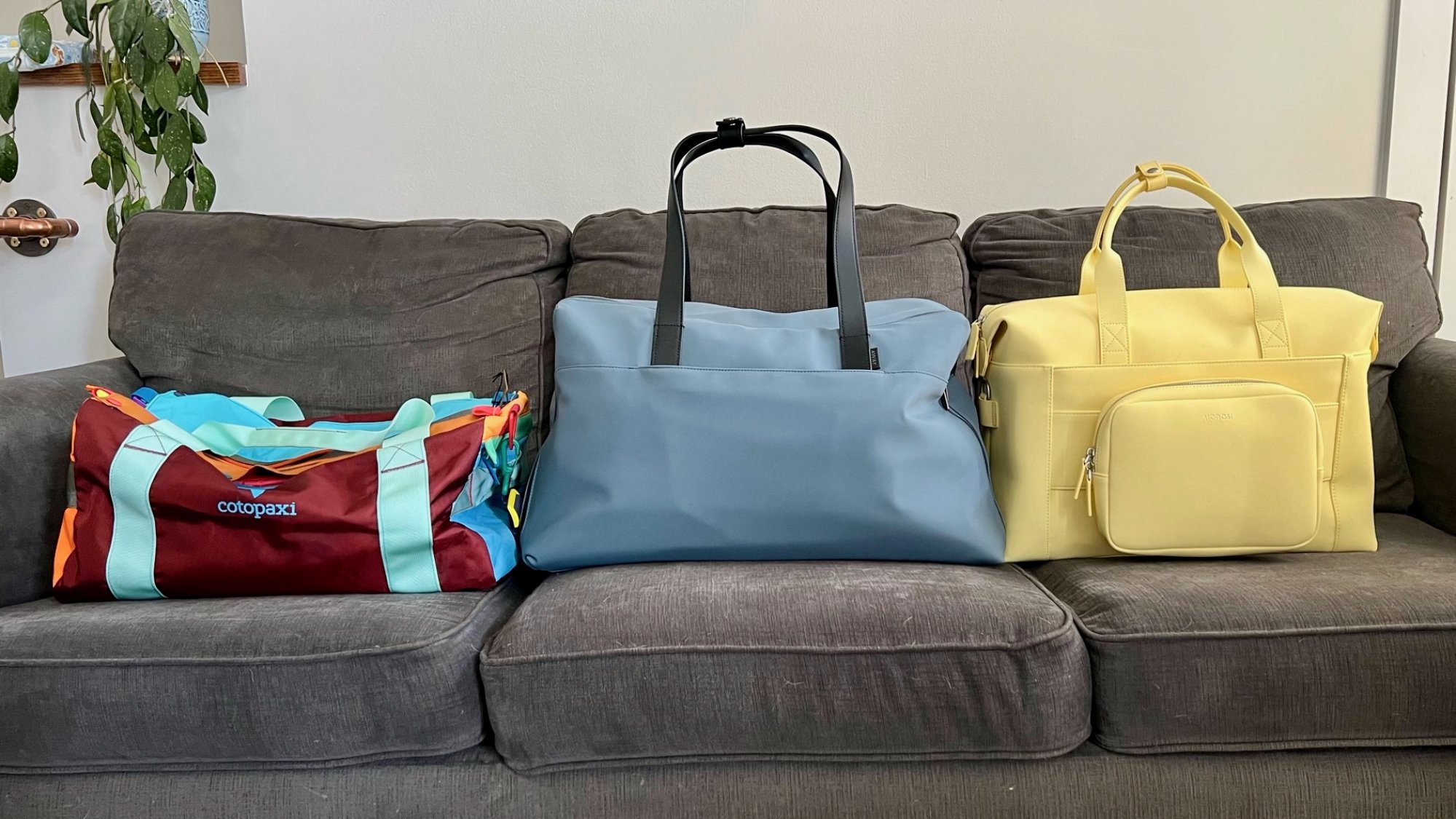 three duffel bags on a couch