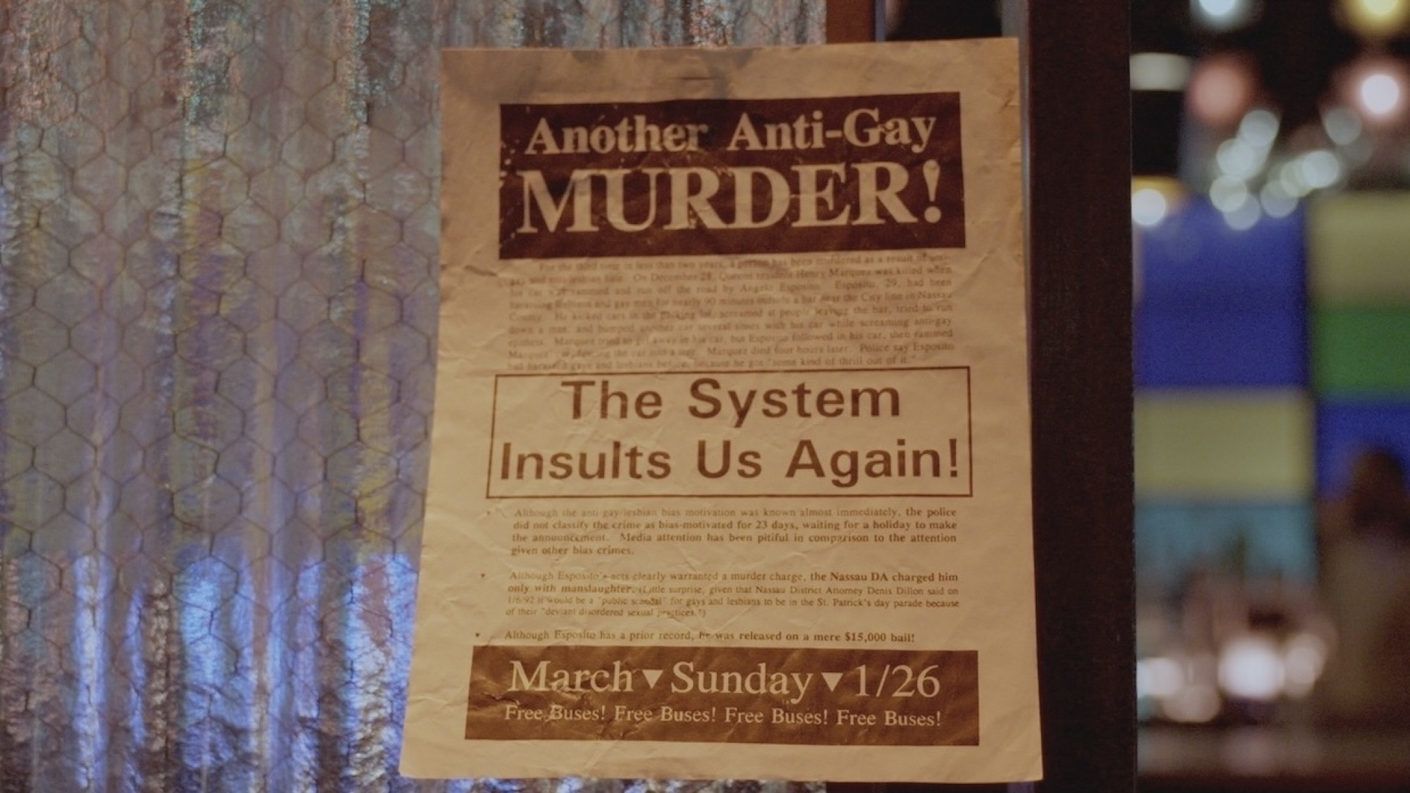 A flyer on a bar window that reads "Another anti-gay murder! The system insults us again!"