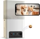 Petcube pet camera flinging treat and smartphone with cat and dog on screen