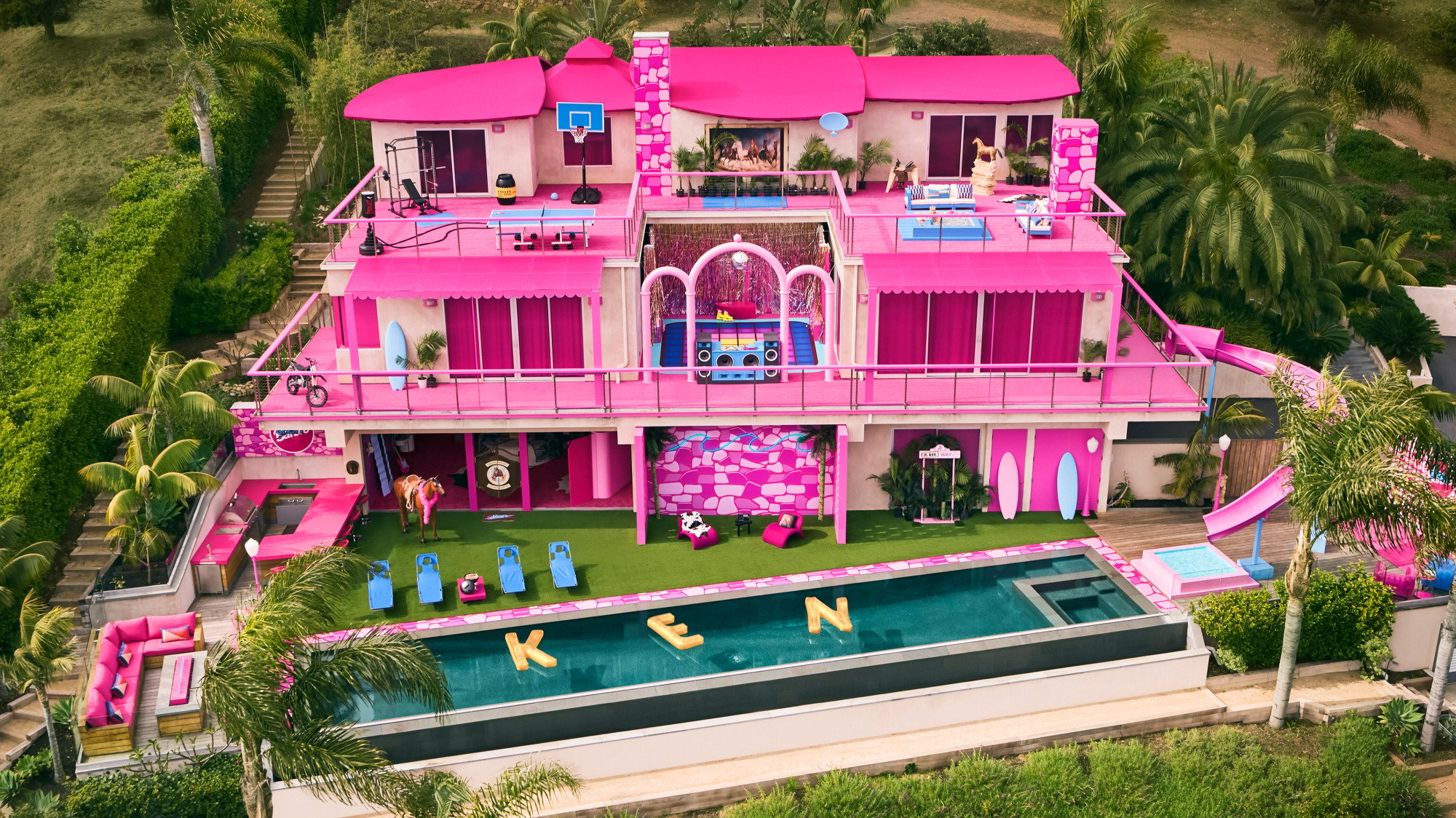A drone image of a pink mansion. 