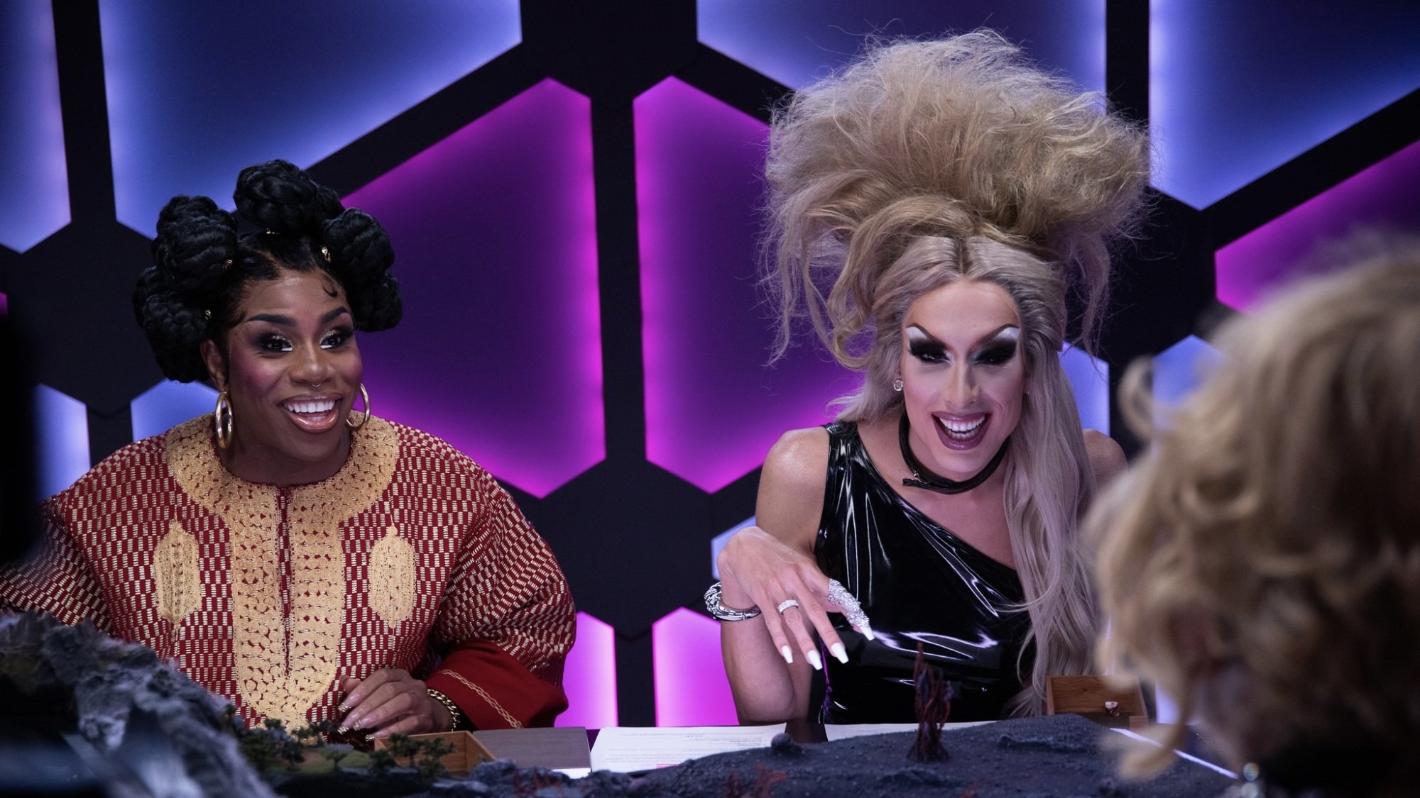 Drag queen Monét X Change and Alaska Thunderfuck laugh while playing "Dungeons and Drag Queens."