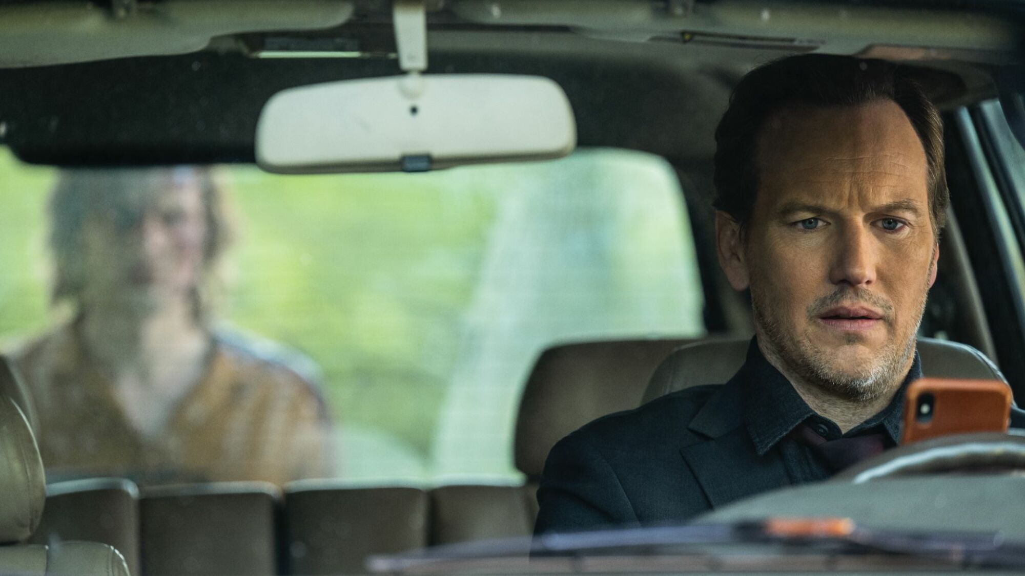 Patrick Wilson sits in a car, followed by a ghost in "Insidious: The Red Door." 