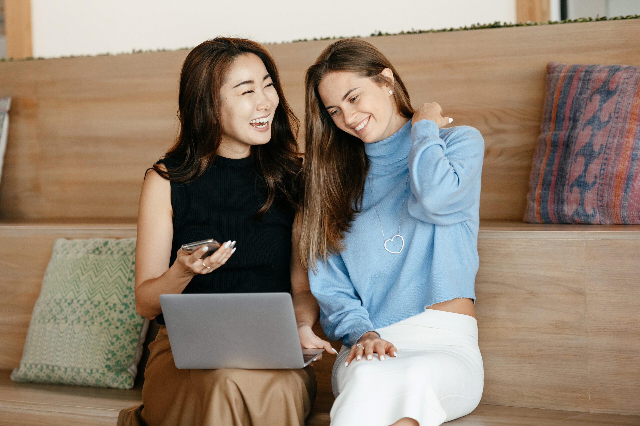 Two girls smiling at phone