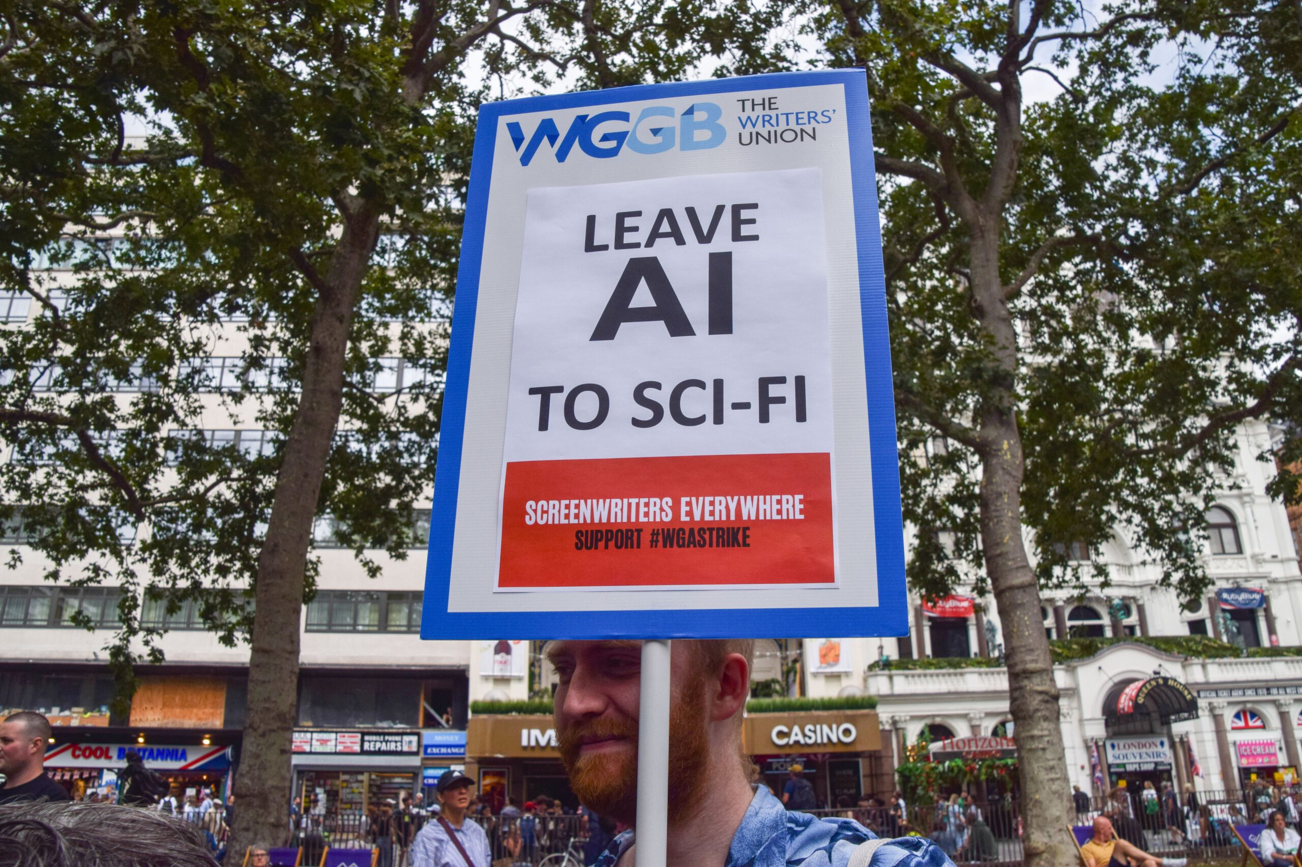 LONDON, UNITED KINGDOM - 2023/07/21: A protester holds a placard opposed to AI (Artificial Intelligence) replacing writers, during the demonstration. Performing arts and entertainment industries union Equity staged a rally in Leicester Square in solidarity with the SAG-AFTRA (Screen Actors Guild American Federation of Television and Radio Artists) strike.