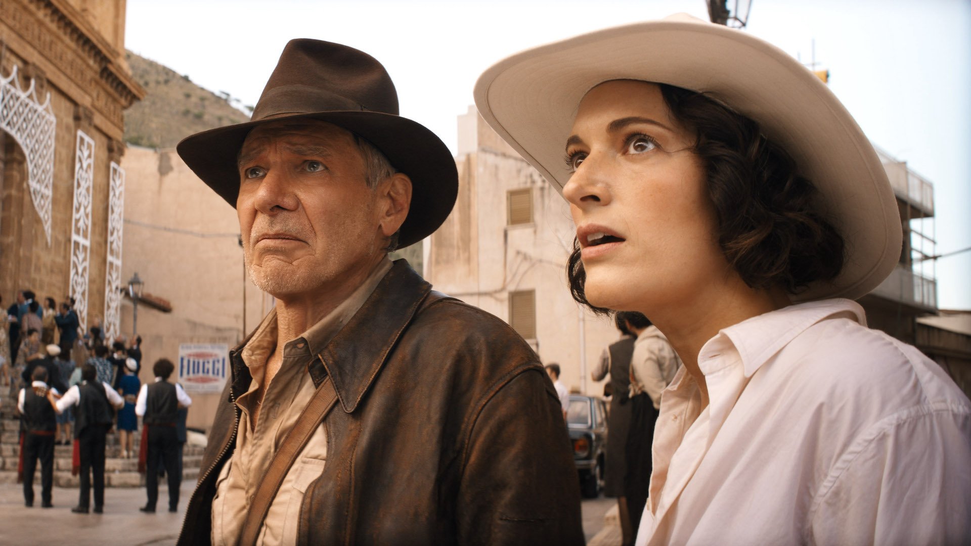 Indiana Jones (Harrison Ford) and Helena (Phoebe Waller-Bridge) stand in a street in 