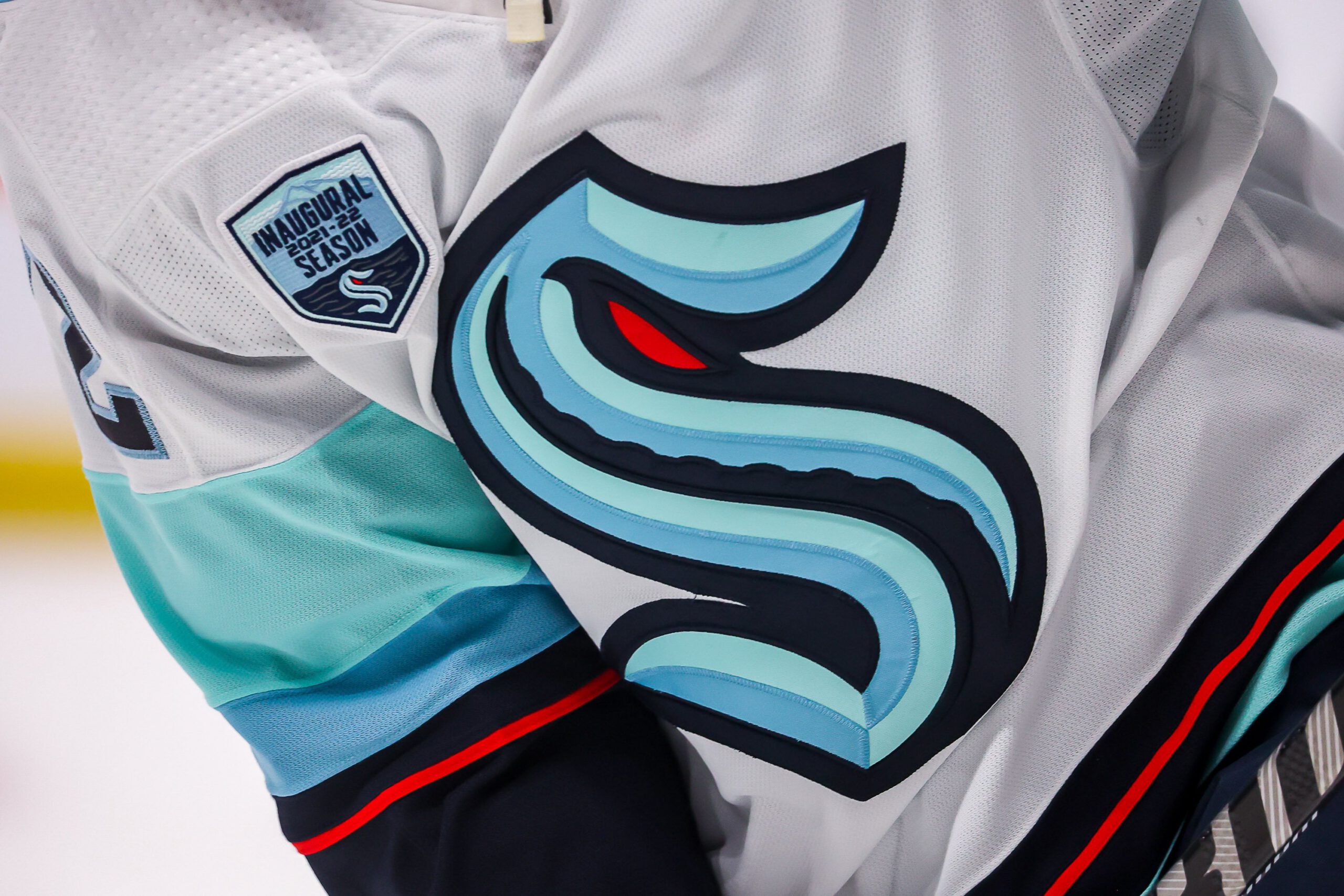 A close-up of a Seattle Kraken jersey on the ice. 