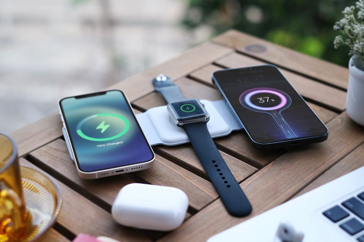 The MagStack charging station shown powering up two phones and a watch. 