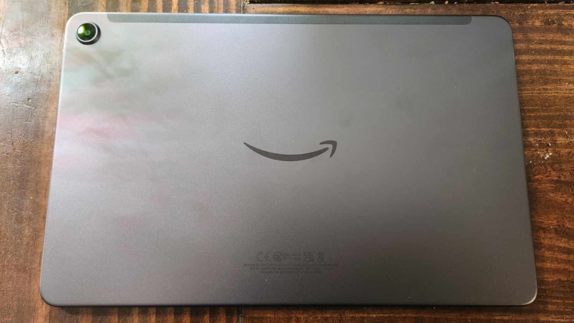 back of amazon tablet with camera lens and amazon smile logo
