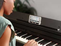Girl playing piano with app on display