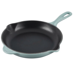 cast iron skillet with light green exterior