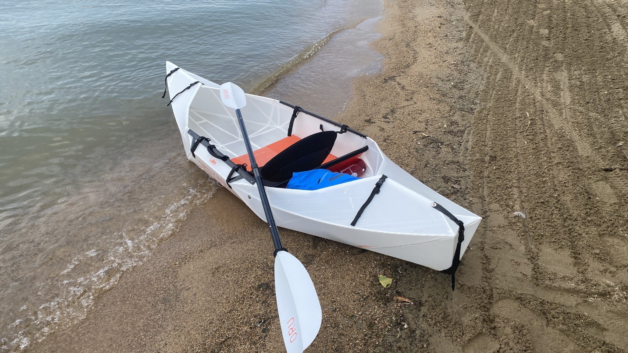 Fully assembled Oru Lake kayak on a lake shore