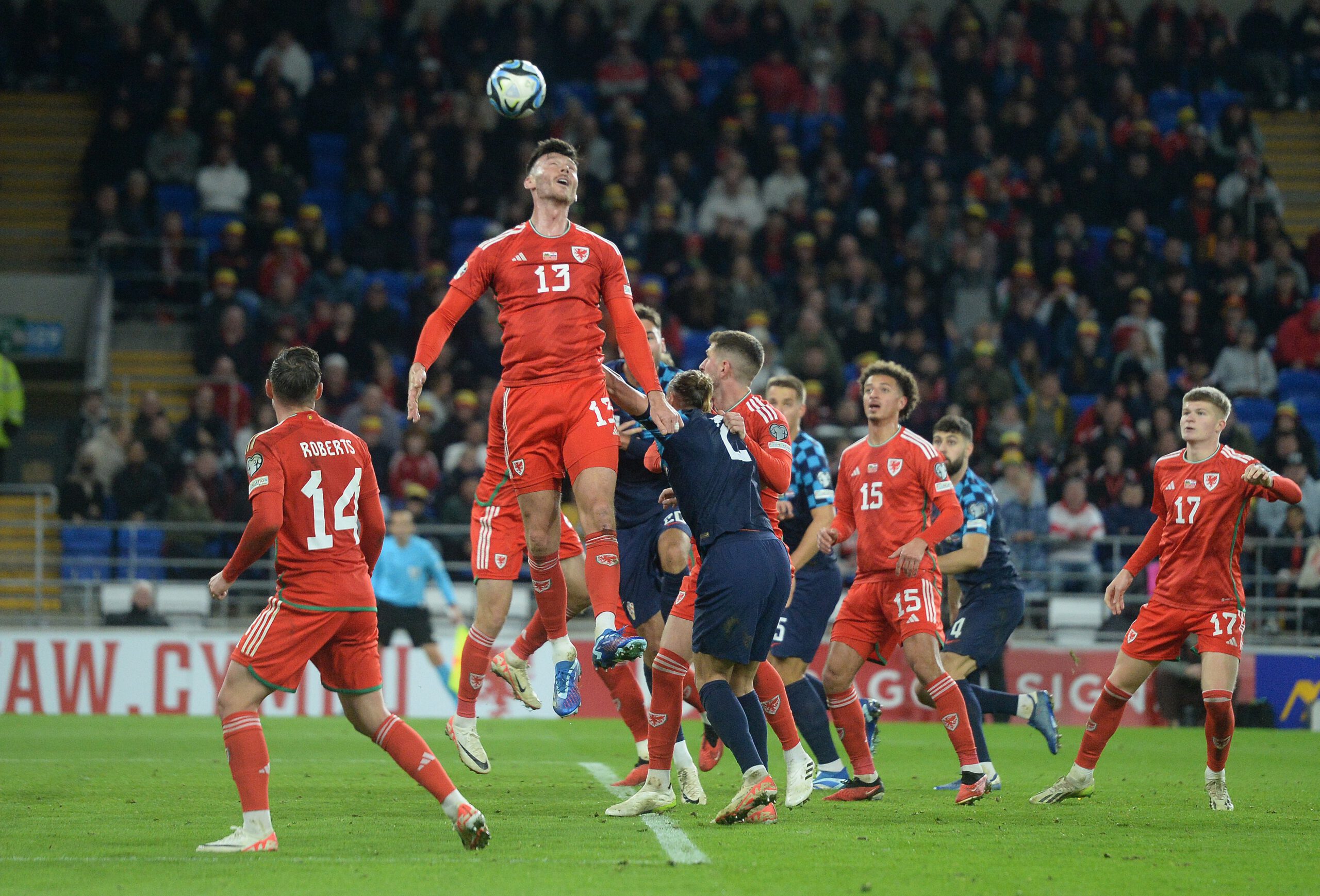Wales' Kieffer Moore heads the ball clear