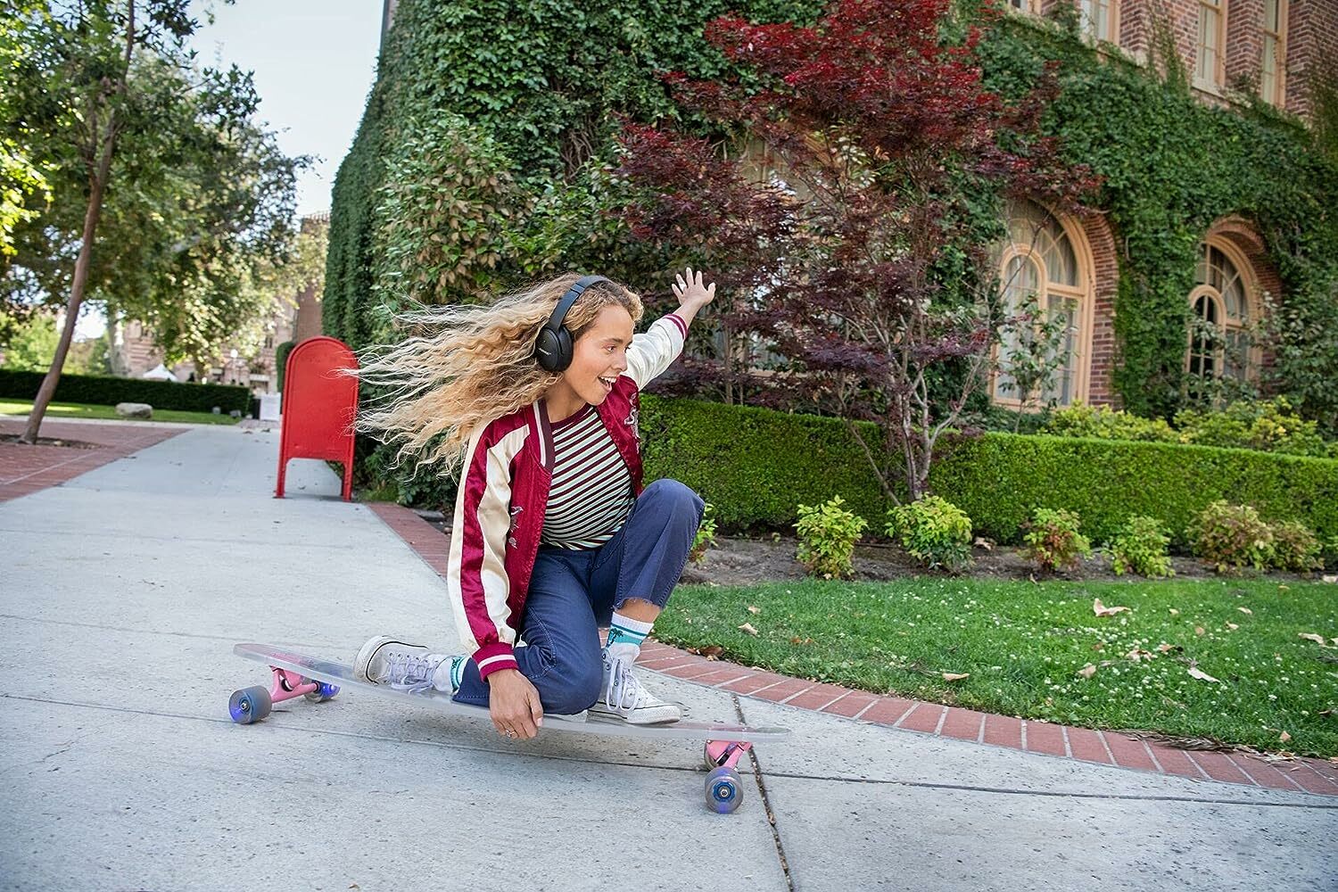 Girl riding skateboard with Bose headphones