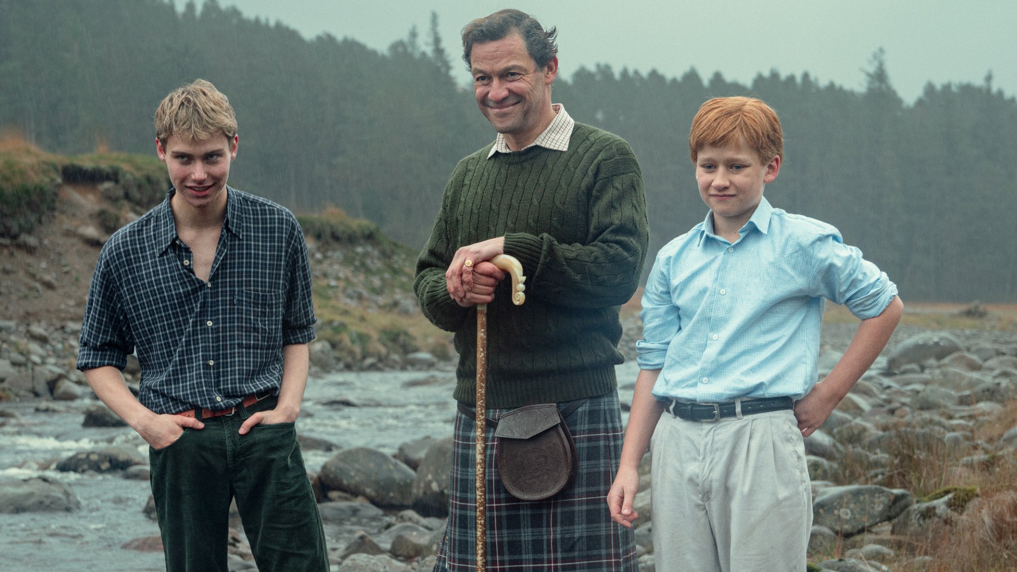 Prince William (Ed McVey), Prince Charles (Dominic West), and Prince Harry (Luther Ford) pose for a photo in the country.