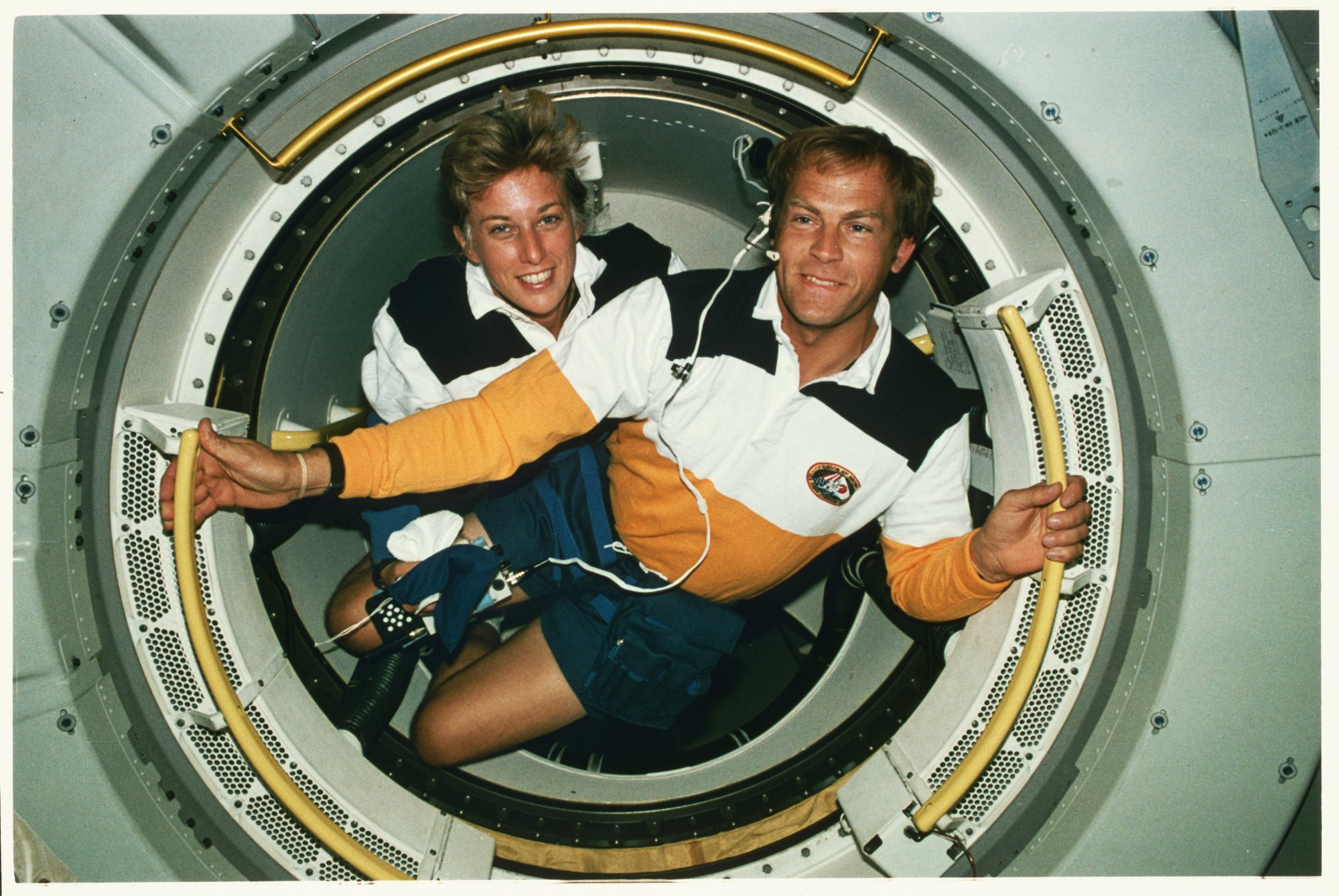 NASA astronauts Mark Lee and Jan Davis floating in microgravity