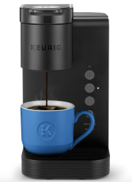 Black Keurig pouring coffee into blue mug