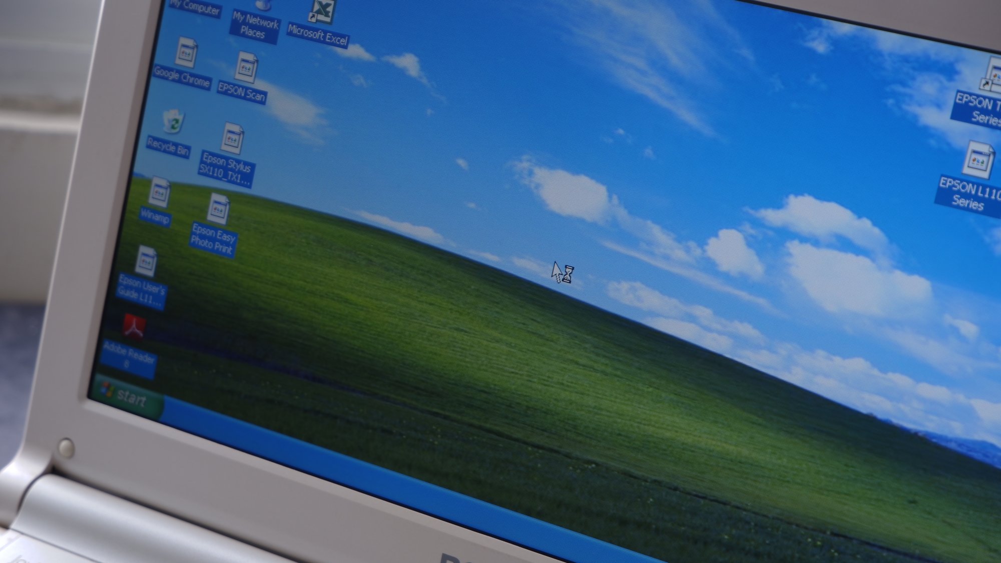 Windows XP Bliss wallpaper on a laptop
