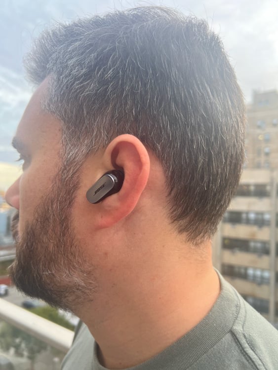 the author wearing bose quietcomfort ultra earbuds