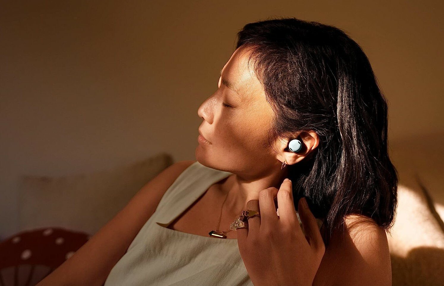 Woman relaxes with Google Pixel Buds Pro