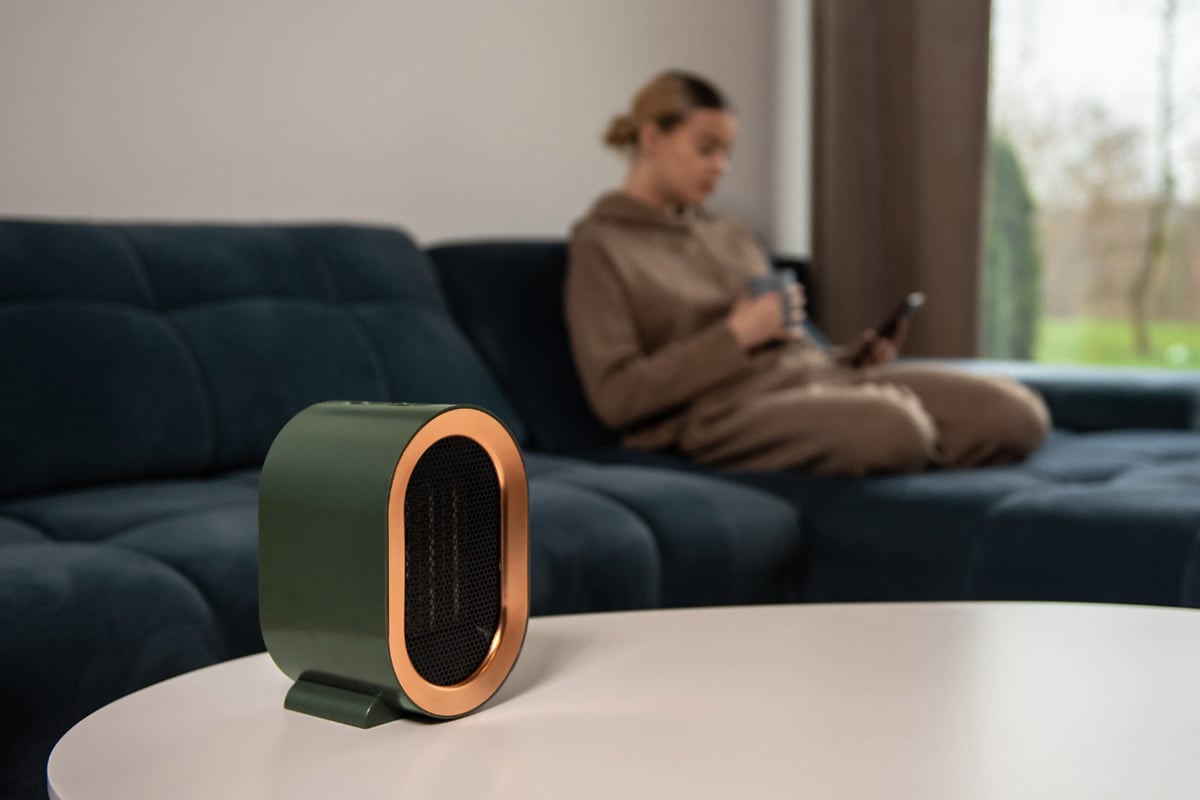 space heater with woman in background