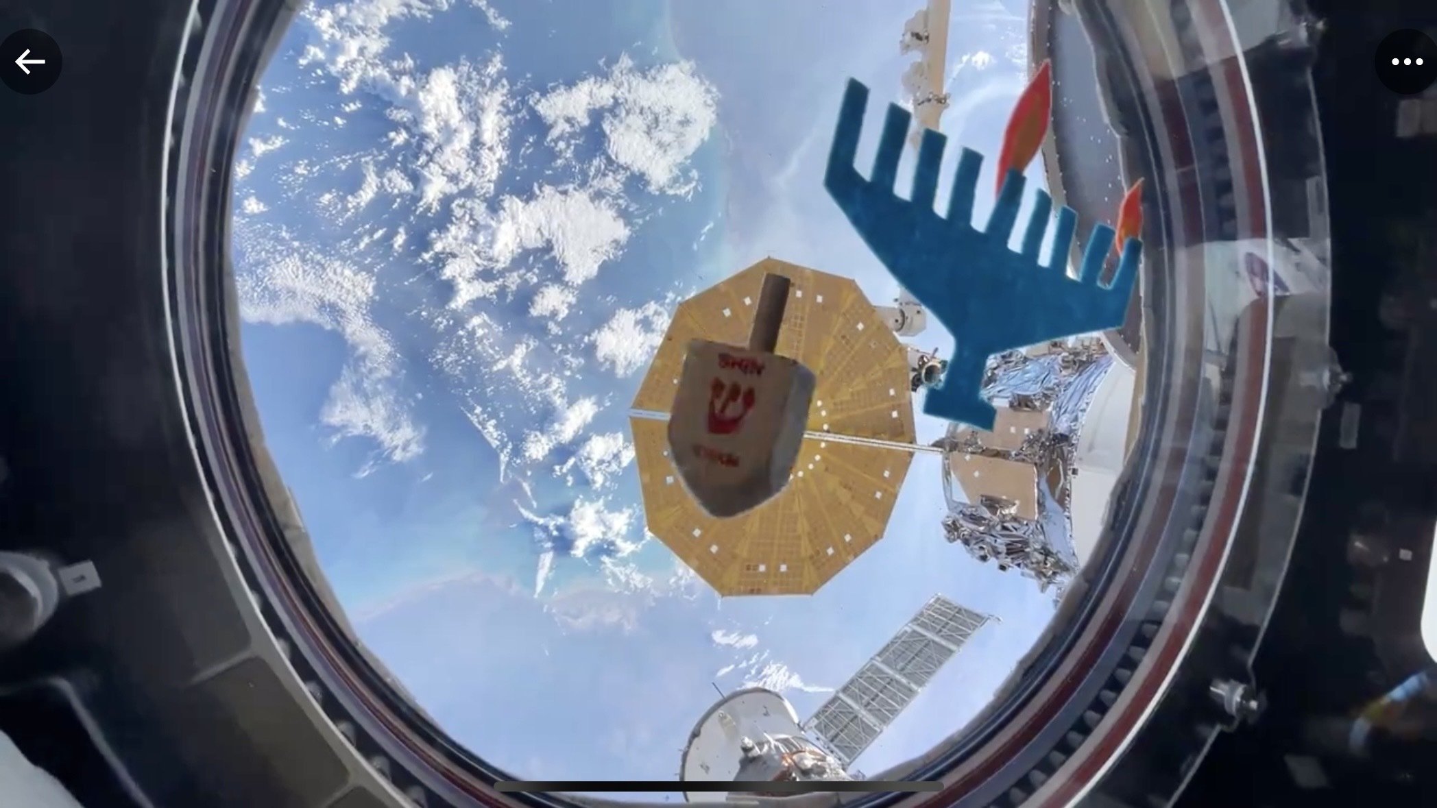 Astronaut spinning dreidel in space