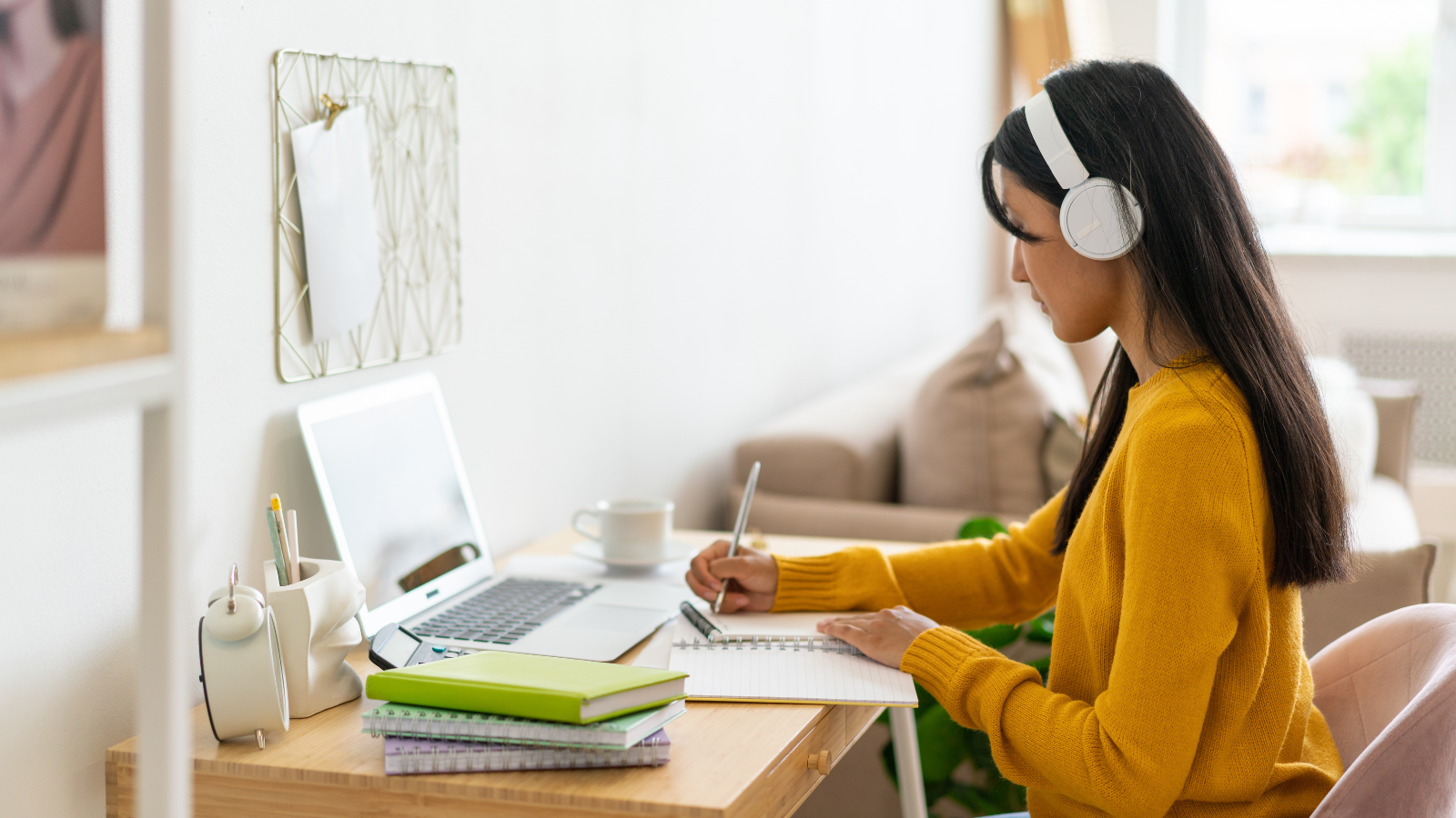woman taking online course on laptop wearing headphones