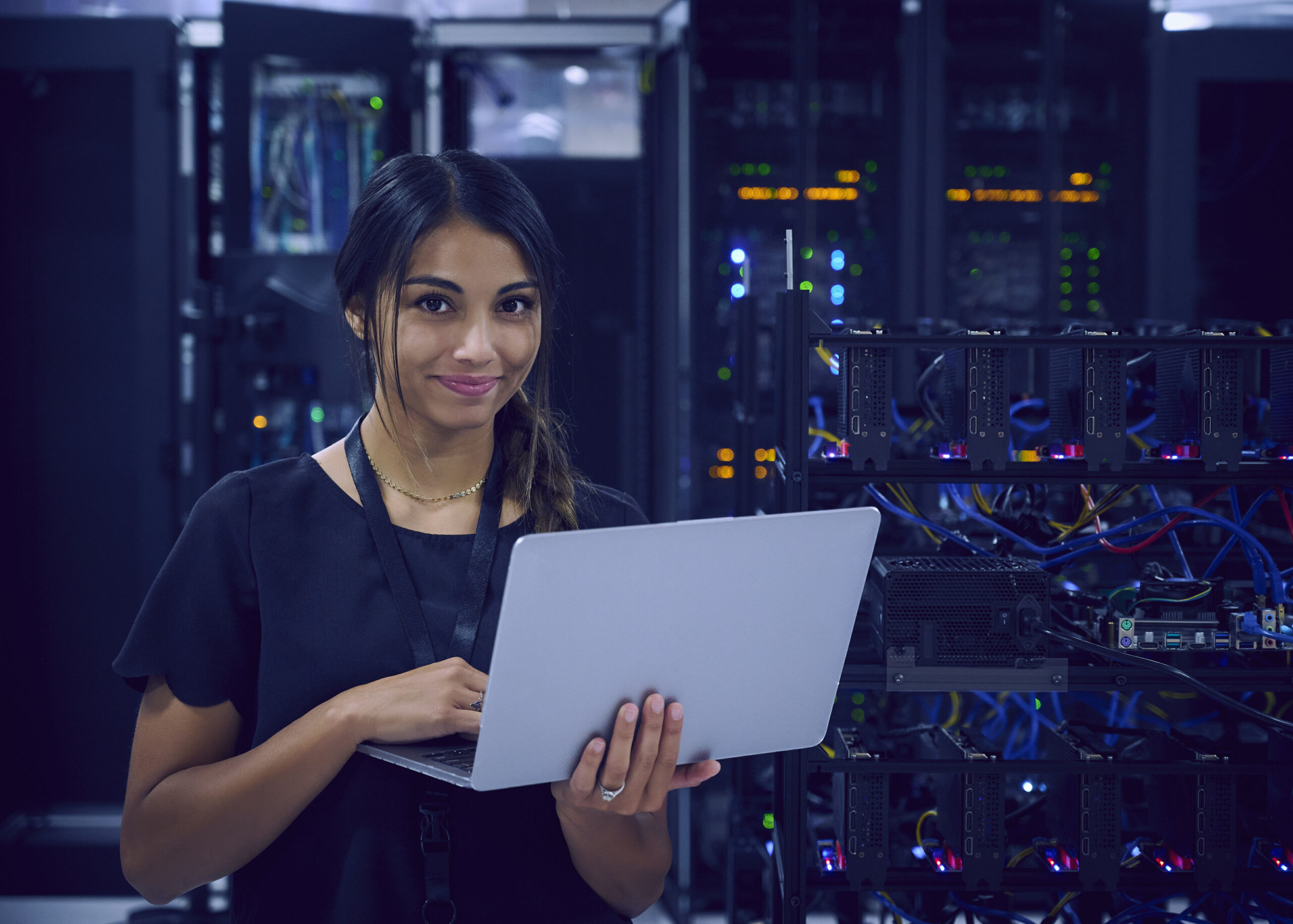 woman using laptop in server room