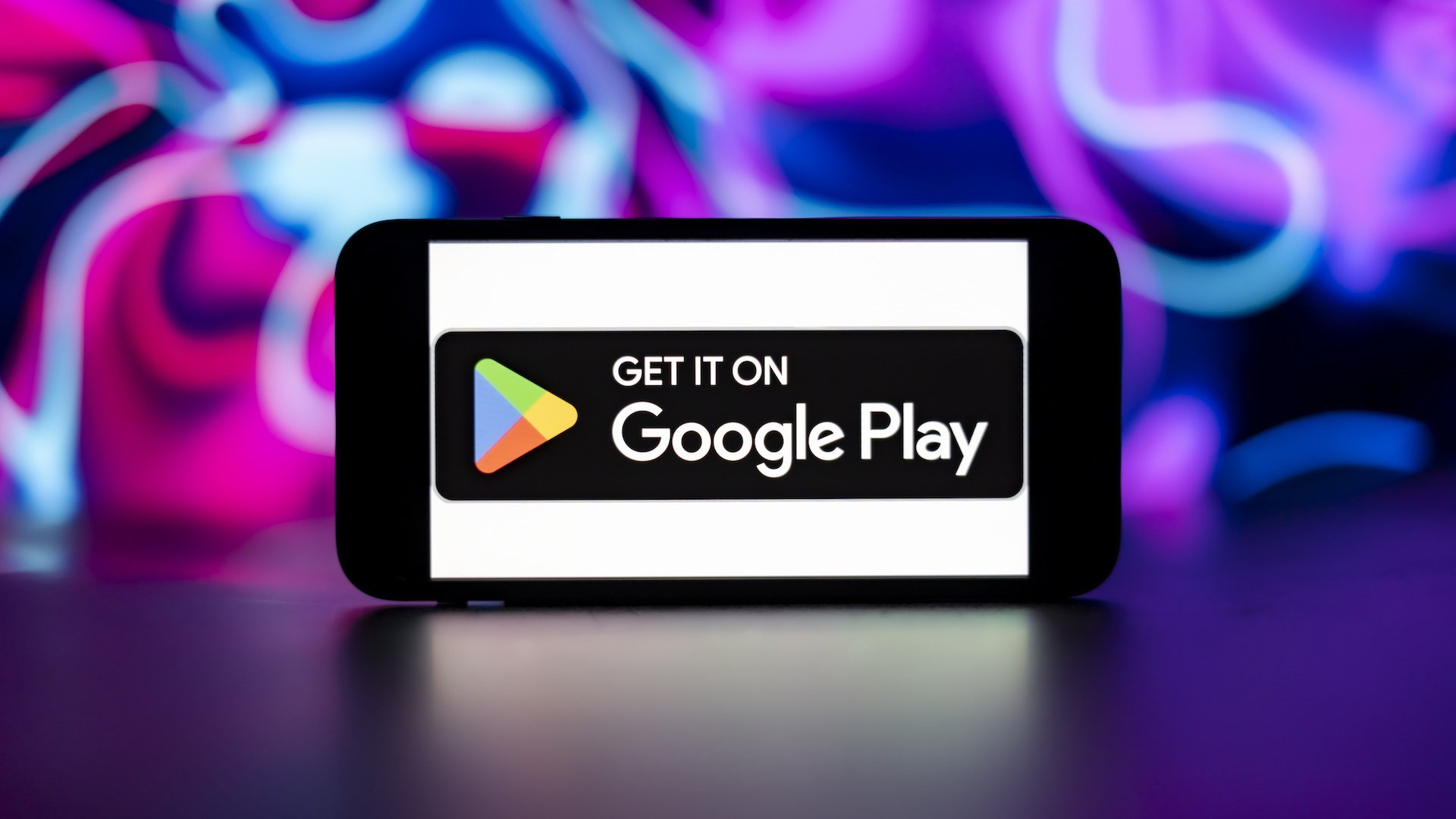 Google play store logo is seen displayed on a mobile phone screen.