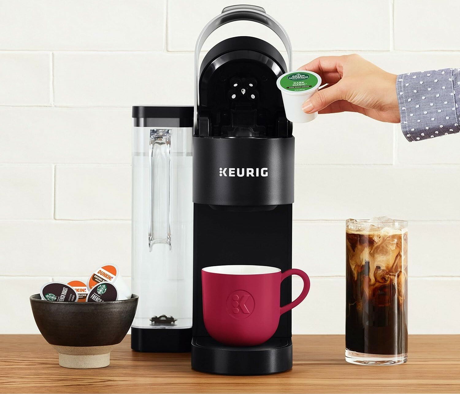 Keurig K-Supreme Single-Serve coffee maker pictured with a bowl of K-Cups and an iced coffee