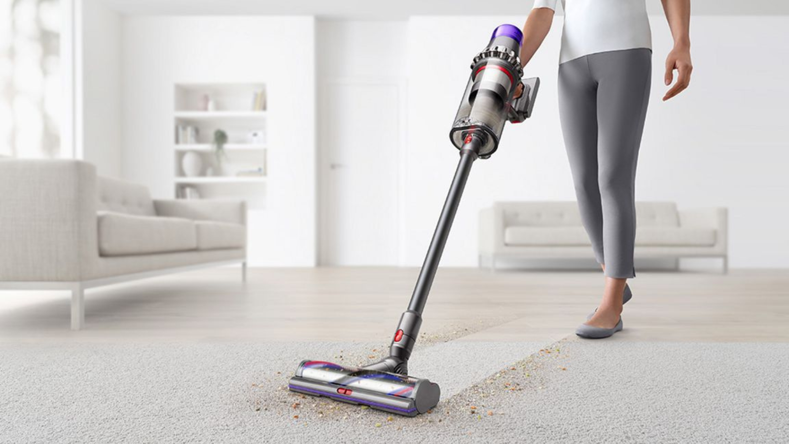 woman vacuuming rug with dyson outsize plus