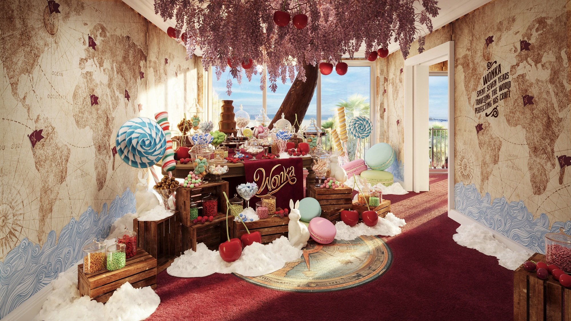 A "Wonka"-themed hotel room with a large chocolate tree and lollipops at its center.