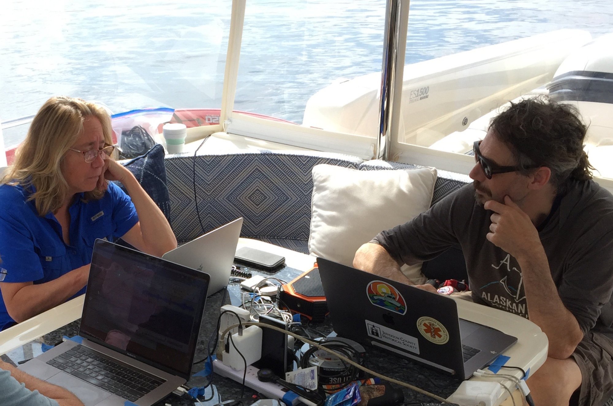 Researchers Brenda McCowan and Fred Sharpe working aboard a vessel.