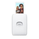 The Fujifilm Instax Mini Link 2 printer with a photo of two people it just printed