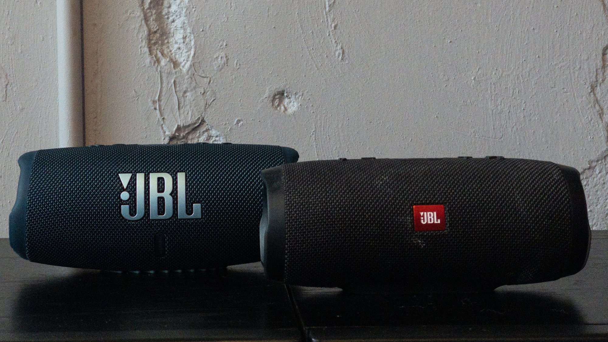 jbl charge 5 and jbl charge 3 speakers next to each other