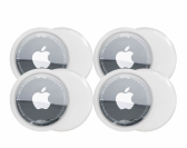 Four Apple AirTags laid out over a white background